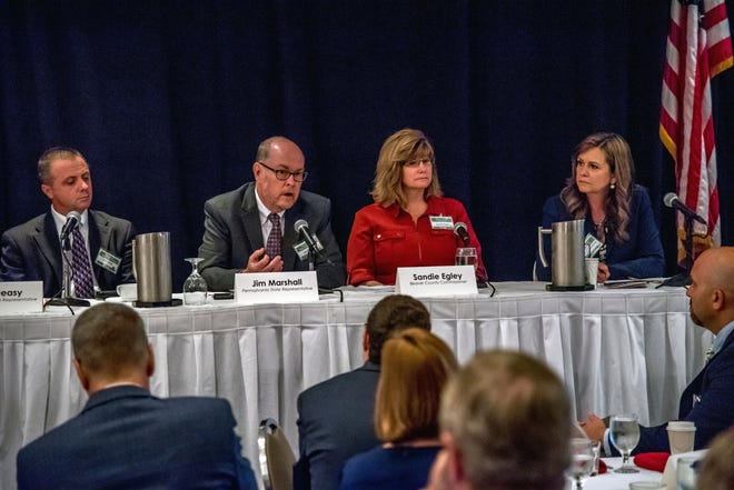 State Sen. Camera Bartolotta, far right, and Beaver County Commissioner Sandie Egley, second from right, listen as state Rep. Jim Marshall, second from left, speaks at the Pittsburgh Airport Area Chamber of Commerce's legislative breakfast on Friday. [Doug Hughey/For BCT]