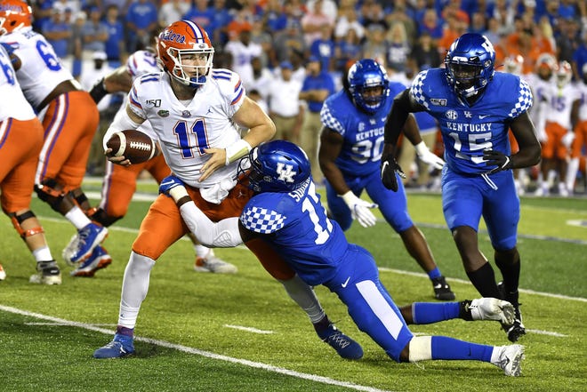 Kentucky linebacker DeAndre Square (17) tries to bring down Florida quarterback Kyle Trask (11) during the second half of a game on Sept. 14 in Lexington, Ky. [AP Photo/Timothy D. Easley]