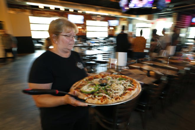 In this GateHouse Media file photo, Julie Mialki works at her Giuseppie's Steel City Pizza restaurant in Port Orange, Florida, Monday, May 6, 2019. [News-Journal/Nigel Cook]