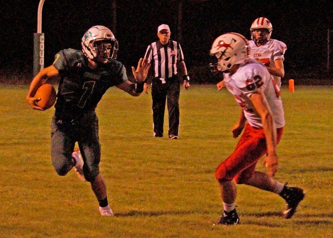 Cougar Angel Nicholas looks for running room during Friday's home game vs. Etna. 
Photo by Dave Sjostedt