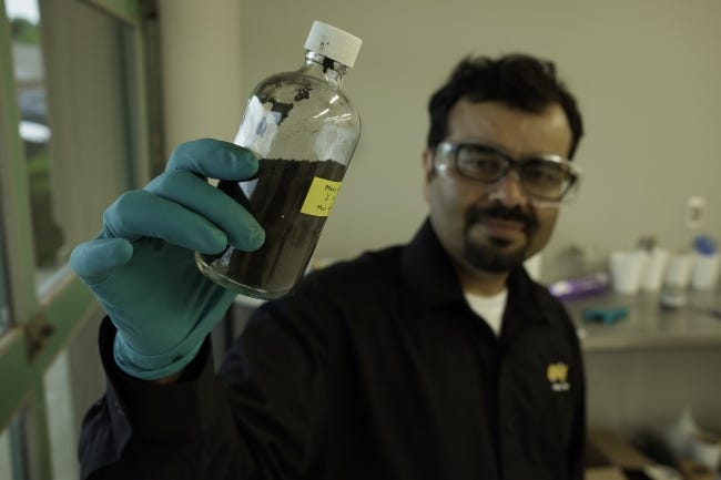 Bhishma Sedai, MITO Material Solutions vice president of research and development, holds a sample of the hybrid nanoparticle the company produces. The product can be infused into a coating that improves durability of other materials. [PHOTO PROVIDED]