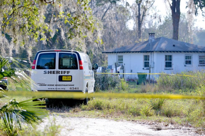 Officials investigate the scene where 92-year-old Rubye James' body was found in a shallow grave off East Main Street on Feb. 9, 2017, in Leesburg. In a study conducted by BackgroundChecks.org, Leesburg ranks No. 127 of 134 Florida cities surveyed. [DAILY COMMERCIAL FILE]