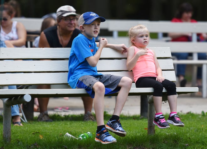 Siblings Reese, 9, and Aubrey Edwards, 5, use sign language during the annual Storytelling Festival, Saturday at Ewing Park. Misty Mator, also known as Starla the Storyteller, encouraged the audience to respond with sign language during parts of her story.

[Sally Maxson/for ECL]