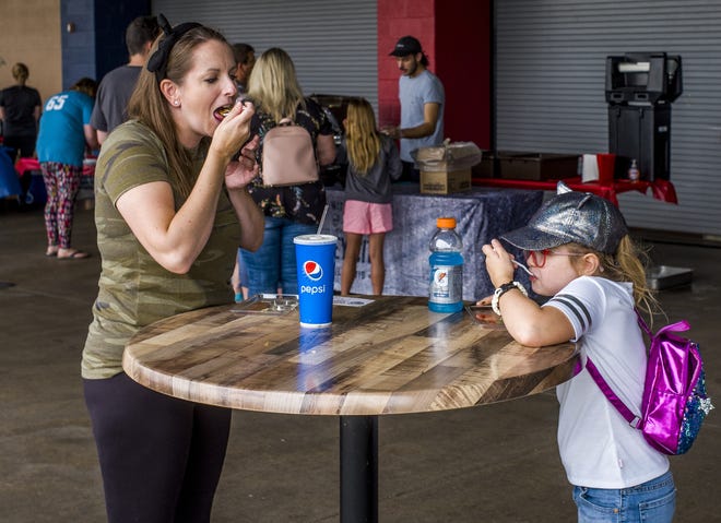 Isabelle Drury, right, takes in a spoonful of chili in a celebration with her favorite food on her 8th birthday with her mother, Anna, on Sunday at the 2019 Build Peoria Chili Cook-Off at Dozer Park. Money raised in the competition will fund this year's project of building shelters at CityLink bus stops. [DAVID ZALAZNIK/JOURNAL STAR]