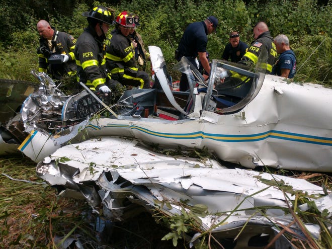 Polk County Fire Rescue, FAA investigators and other emergency personnel inspect the remains of a small plane that crashed near Mulberry on Monday. [PROVIDED PHOTO/POLK COUNTY SHERIFF'S OFFICE]