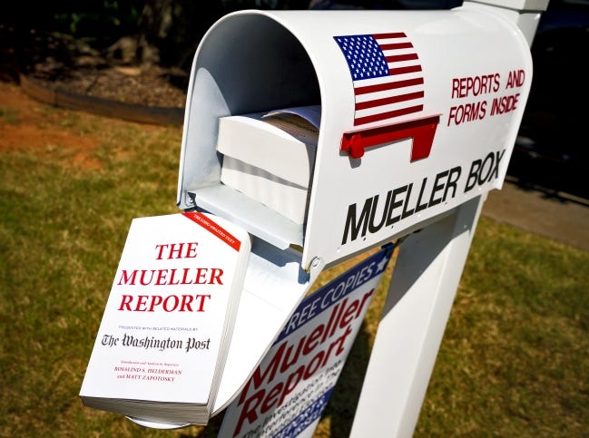 Nick and Louise Brooke give away free copies of the Mueller Report at their home in Oklahoma City. [Chris Landsberger/The Oklahoman]