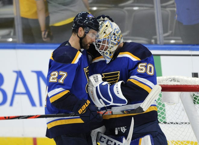 The St. Louis Blues' Jordan Binnington (50) is congratulated by teammate Alex Pietrangelo (27) after their 5-3 victory over the Columbus Blue Jackets in a preseason game in St. Louis. [BILL BOYCE/THE ASSOCIATED PRESS]