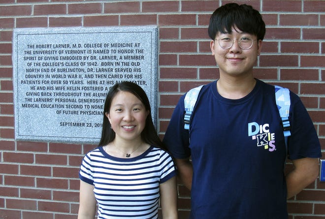 In this Aug. 16 photo, Chinese graduate students Zhaojin Li, left, and Pengfei Liu, pose in front of the entrance to the Robert Larner College of Medicine at the University of Vermont in Burlington, Vt. Some higher education officials are concerned by a drop in the number of international students coming to the United States, especially from China. Li and Liu say that some of their relatives were concerned for their safety in coming to the United States, but they are too busy with their studies to focus on geopolitical issues. [WILSON RING/ASSOCIATED PRESS]