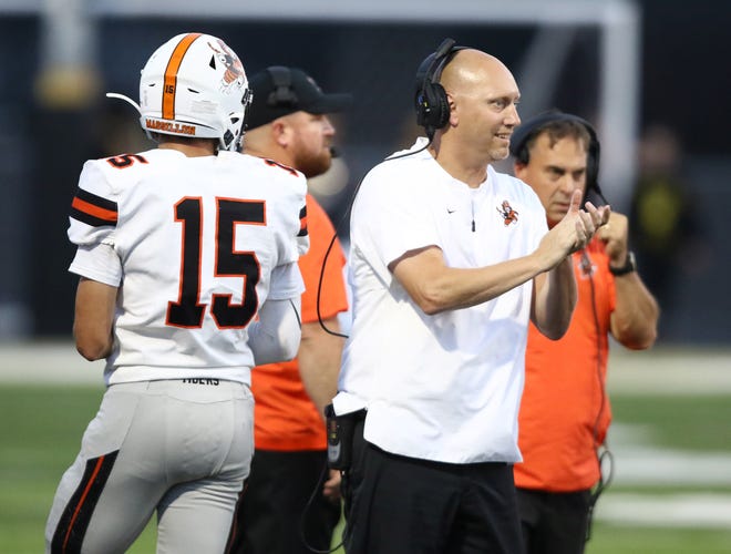 Massillon safeties coach Dan Hackenbracht claps as the defense comes to the sideline during a Week 3 win over Warren Harding. Also pictured are assistant coaches Jason Jarvis, left rear, and Dave Weber.

(IndeOnline.com / Kevin Whitlock)