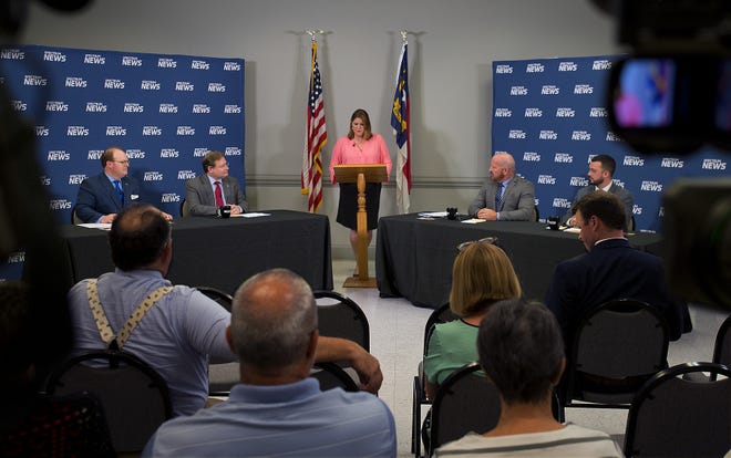 Moderator Loretta Boniti (center) begins the North Carolina Institute of Political Leadership's 2019 Hometown Debate Series about Medicaid Expansion and Transformation with panelists Wayne Goodwin, Nelson Dollar, Roy Lenardson and Brendan Riley (from left) at the J. Smith Young YMCA on Tuesday night. [Donnie Roberts/The Dispatch]