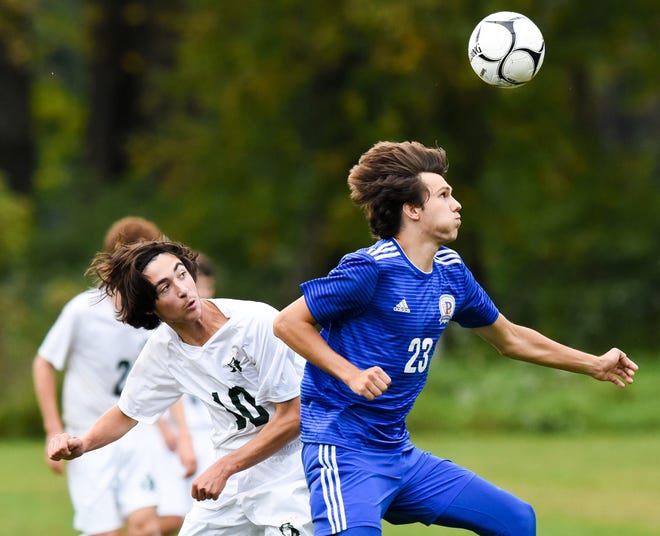 Hamilton's Spencer Thomas (10) fights for possession of the ball with Poland's Jarrett Papp (23) on Tuesday at Kuyahoora Town Park in Poland, New York. Poland won the boys soccer game 2-0. 

[Alex Cooper / Observer-Dispatch]