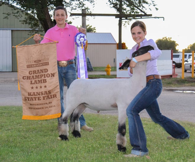 Gabryelle Gilliam of Washington poses with her grand champion lamb Sept. 10, 2016, while her brother, Jack, holds her ribbon and banner. State Fair officials later disqualified the entry, but a Reno County judge last week reversed the disqualification. [Adam Stewart/Hutchnews]