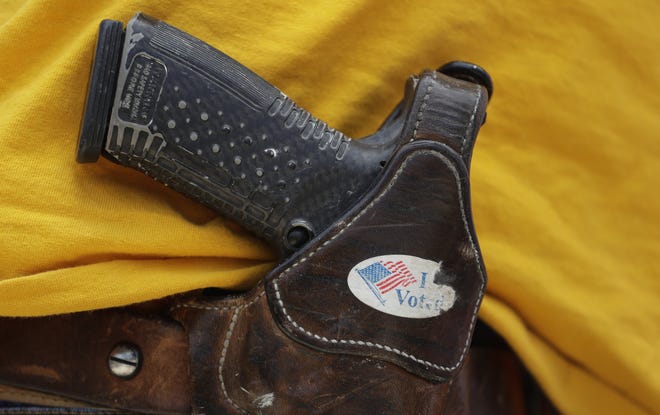 In this April 14, 2018, file photo, a man wears an unloaded pistol during a pro gun-rights rally in Austin, Texas. [AP Photo/Eric Gay, File]