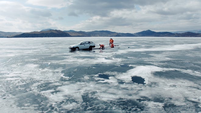 Police work to retrieve a car that had fallen through the ice of Lake Baikal in a scene from the film "Aquarela." MUST CREDIT: Handout courtesy of Victor Kossakovsky and Ben Bernhard/Sony Pictures Classics