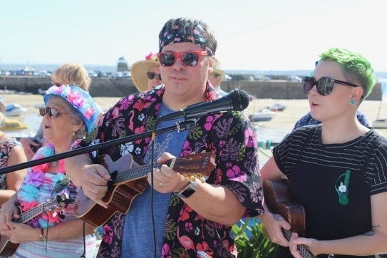 Father-daughter duo, Jason and Galaxy Lineberger, took their ukulele skills across the pond to St. Ives in England to perform with their sister band the Dancing Fleas Orchestra. [Photo courtesy of Dancing Fleas Orchestra]