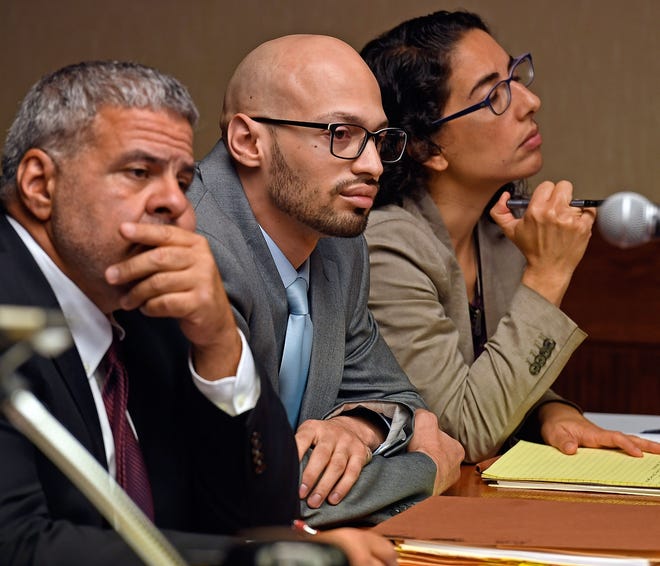 Sergio Correa, flanked by defense attorneys Joseph E. Lopez Sr., left, and Jessica Luu-Missios, right, listens to the testimony of his adoptive sister Ruth Correa during his probable cause hearing in New London Superior Court last week. Sergio Correa is charged in the murders of three members of the Lindquist family in Griswold in 2017. [Sean D. Elliot/The Day]