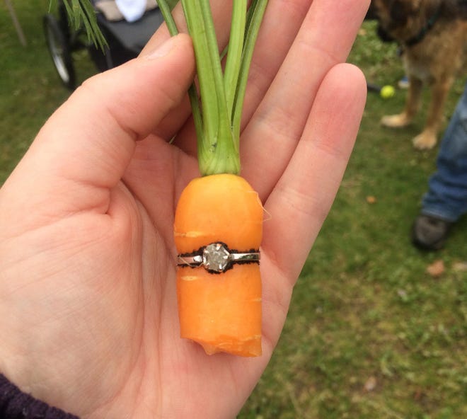 Danielle “DeeJay” Squires holds her engagement ring on a carrot. MUST CREDIT: Courtesy of Danielle “Deejay” Squires