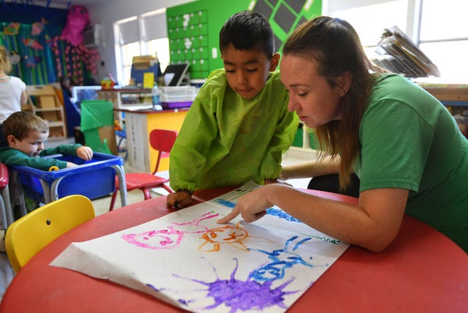 Preschool student Benjamin Salgado explains his painting to VPK teacher Amber Halscheid so she can annotate it for his parents at Bizzy B2 day care on Friday, Mar. 9, 2019 in Sarasota.  [Herald-Tribune staff photo / Mike Lang]