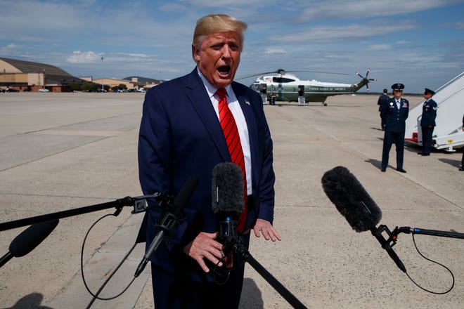President Donald Trump talks with reporters after arriving at Andrews Air Force Base, Thursday, Sept. 26, 2019, in Andrews Air Force Base, Md. (AP Photo/Evan Vucci)