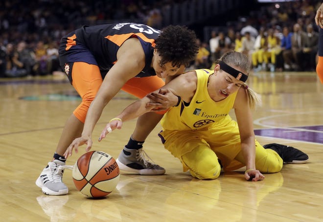 Connecticut Sun’s Layshia Clarendon, left, works for a loose ball against Los Angeles Sparks’ Sydney Wiese on May 31, 2019, in Los Angeles. Clarendon has recovered from ankle surgery and is hopng to get back on the floor for the WNBA finals series. [Marcio Jose Sanchez/The Associated Press]
