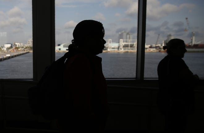 In this Sept. 6 file photo passengers board a ferry that departs from Port Everglades in Fort Lauderdale. [AP Photo/Brynn Anderson, File]