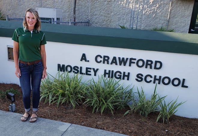 Assistant Administrator Stacey Brady poses in front of Mosley High School. [CONTRIBUTED PHOTO]