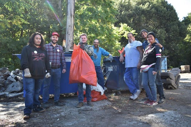 River Exchange volunteers along with Dunsmuir community members display some of the trash that was collected along the upper Sacramento River during the 27th Annual River Exchange Cleanup Saturday morning.