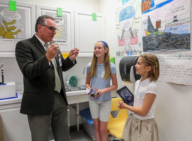 Peter Licata, a regional superintendent in the Palm Beach County School District, pictured with two students in 2016. [Damon Higgins / The Palm Beach Post]