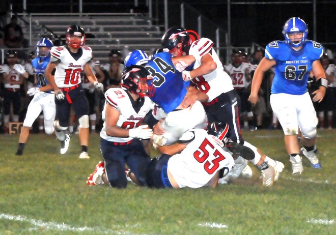 Buckeye Trail senior Ronnie Rominger (34) is taken down by a crew of the Indian Valley defenders including Caleb Wells (53) and Cole Lancaster (18). With late help arriving from Andrix Bowersock (10).