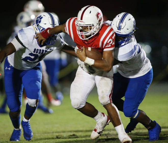 Crestview running back Taylor Scarbrough tries to gain extra yardage as Crestview hosted Godby earlier this season. [MICHAEL SNYDER/DAILY NEWS].
