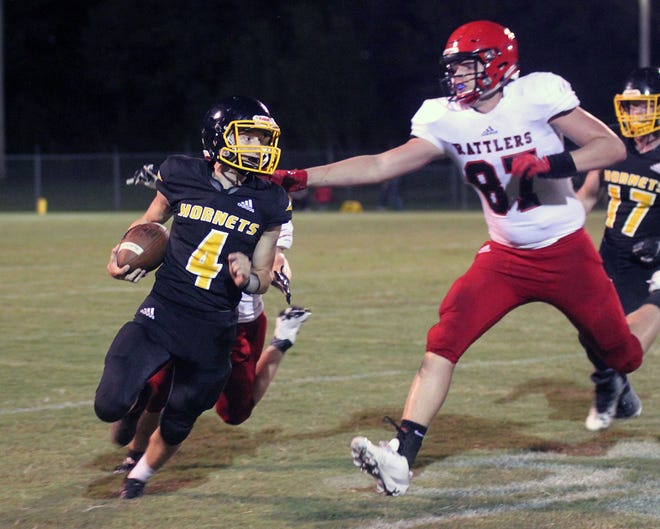 Hackett quarterback Avery Hester attempts to cut back as Magazine defender Cameron Raggio looks to stop him in the second quarter at Mills Field in Hackett on Friday, Sept. 27, 2019. [AARON SHAFFER/SPECIAL TO THE TIMES RECORD]