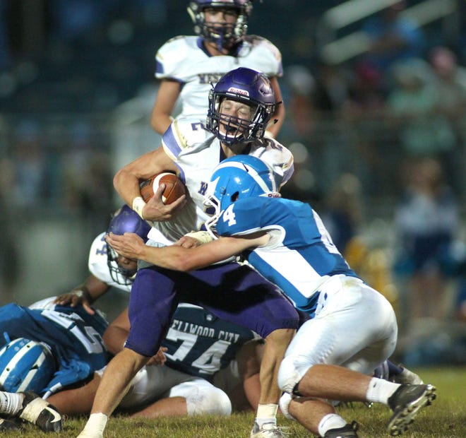 Western Beaver's Thad Gray (2) attempts to avoid Ellwood City's Nick Magnifico (4) during the second half Friday at Helling Stadium. Gray rushed for 153 yards and two scores in the Golden Beavers' win. [Michael Longo/For BCT]