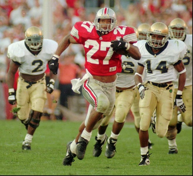 Ohio State 's Eddie George (27) runs for a touchdown against Notre Dame in front of the Irish's Ivory Covington (14) and Kinnon Tatum (2) on Saturday, Oct. 5, 1995. [File photo]