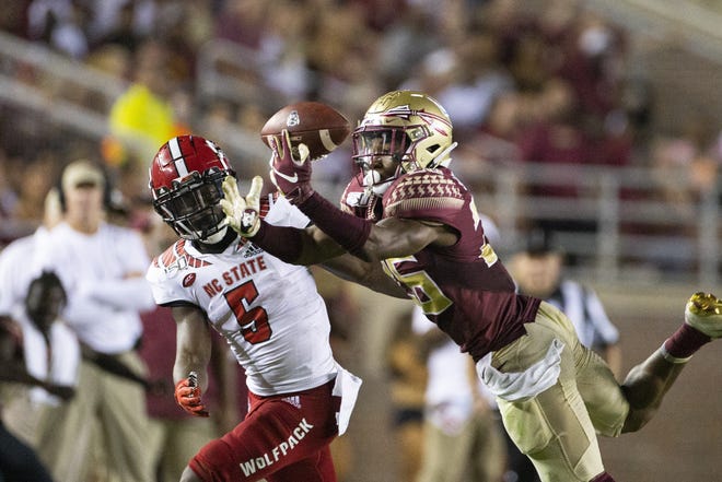 Florida State Seminoles defensive back Asante Samuel Jr. (26) tries to intercept a pass intended for North Carolina State wide receiver Tabari Hines (5) in the second half of an NCAA college football game in Tallahassee, Fla., Saturday, Sept. 28, 2019. Florida State defeated North Carolina State 31-13. (AP Photo/Mark Wallheiser)