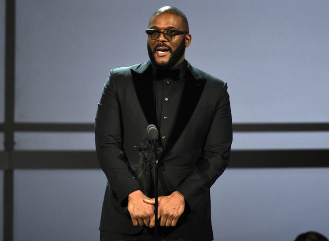 FILE - This June 23, 2019 file photo shows Tyler Perry accepting the ultimate icon award at the BET Awards in Los Angeles. Perry says he cannot "just up and leave" filming in Georgia despite Hollywood's backlash against the state's "heartbeat" abortion law. Perry made the remarks Friday, Sept. 27, while discussing the upcoming opening of a massive new Atlanta-based studio. Some celebs have urged TV and film companies to abandon the state after Republican Gov. Brian Kemp signed the restrictive abortion bill in May. (Photo by Chris Pizzello/Invision/AP, File)