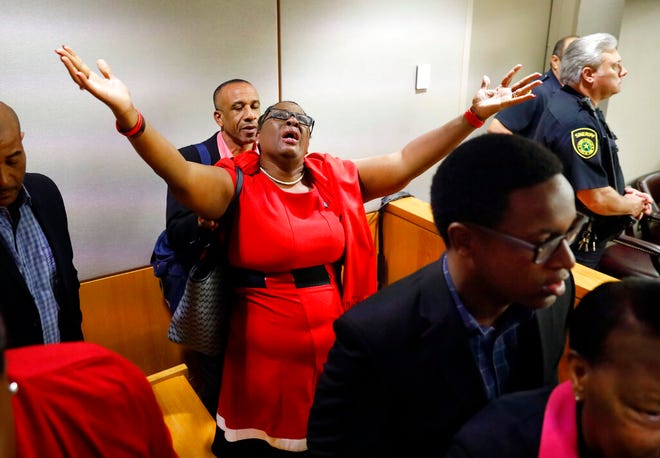 Botham Jean's mother, Allison Jean, rejoices in the courtroom after fired Dallas police Officer Amber Guyger was found guilty of murder, Tuesday, Oct. 1, 2019, in Dallas. Guyger shot and killed Botham Jean, an unarmed 26-year-old neighbor in his own apartment last year. She told police she thought his apartment was her own and that he was an intruder. (Tom Fox/The Dallas Morning News via AP, Pool)