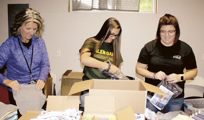 Sue Pyles, Hope Eichorn and Amanda Schemmel recently prepared hygiene packs for Friday’s “Project Connect” event. Hygiene packs, laundry detergent, and fresh and non-perishable food boxes will be given to attendees.[Michelle Patrick/Journal]