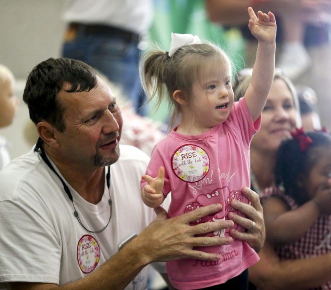 Joe Tucker holds his daughter Addie as she enjoys Big Al, the Alabama cheerleaders and a small part of the Million Dollar Band during a pep rally for students at the Rise Center Friday, Sept. 27, 2019. [Staff Photo/Gary Cosby Jr.]