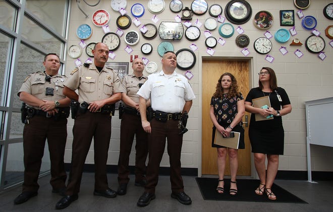 Members of the Sheriff's Office talk about October being Domestic Violence awareness month. [Mike Hensdill/The Gaston Gazette]