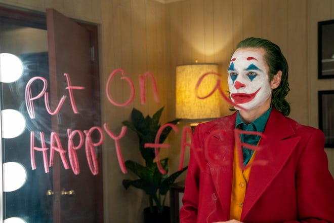 Joker (Joaquin Phoenix) can’t comprehend the meaning of “happy.” [Warner Bros.]