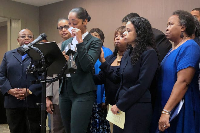 Jazmyne Childs cries during a news conference on Wednesday, Sept. 25, 2019, as she describes the sexual harassment she says she endured while employed by the North Carolina chapter of the NAACP, in Raleigh, N.C. She is asking the national NAACP to expel the man whom she identified as the person who assaulted and harassed her. (AP Photo/Martha Waggoner)