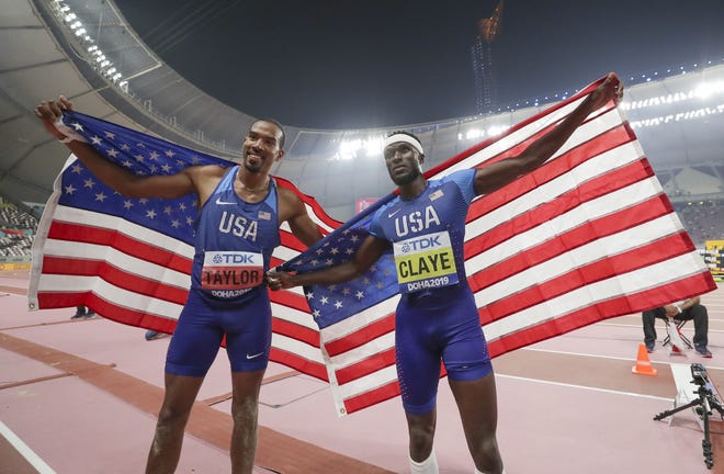 Christian Taylor, left, of the United States, and Will Claye, of the United States, pose together after the men's triple jump final at the World Athletics Championships in Doha, Qatar, on Sunday. Taylor won the gold medal and Claye won the silver. [AP PHOTO BY HASSAN AMMAR]