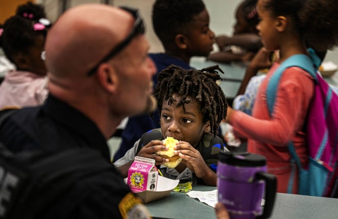 Kindergarteners enjoy breakfast with Gainesville police officers and other local law enforcement agency personnel last Wednesday during First Responders Support Fathers Bring You Kids to School Day at Duval Early Learning Academy.