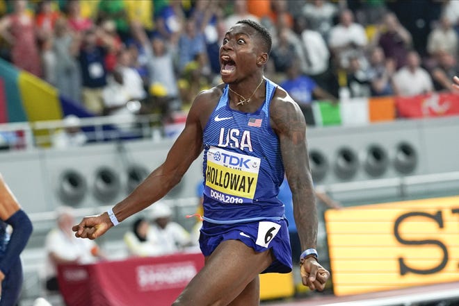 Grant Holloway wins the the men's 110 meter hurdles final Wednesday at the World Athletics Championships in Doha, Qatar. [David J. Phillip/The Associated Press]