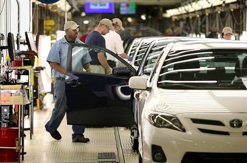 Workers at Manufacturing, Mississippi, Inc., perform a series of inspections on an assembled car prior to its moving to vehicle performance, Thursday, Oct. 25, 2012, in Blue Springs, Miss. (AP Photo/The Commercial Appeal, Stan Carroll)