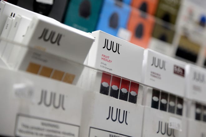 FILE - In this Dec. 20, 2018, file photo Juul products are displayed at a smoke shop in New York. On Thursday, Oct. 3, 2019, the U.S. Federal Trade Commission ordered Juul and five other vaping companies to hand over information about how they market e-cigarettes, the governmentþÄôs latest move targeting the industry. (AP Photo/Seth Wenig, File)