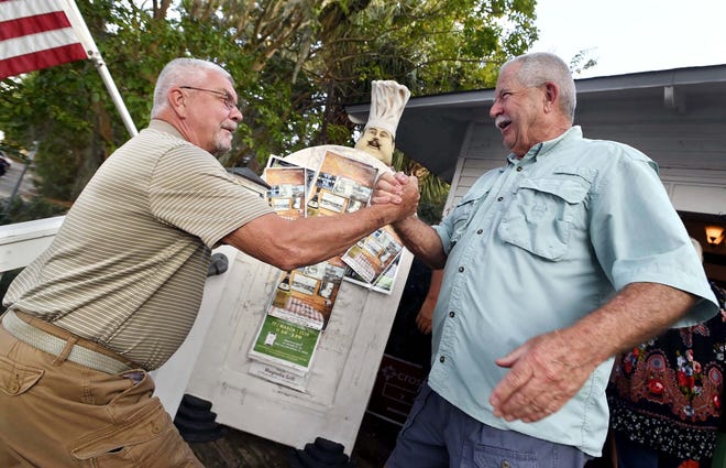 Army veterans Pete Fengl, left, and Mark Smithwick meet again for the first time in 50 years Tuesday evening at the Magnolia Grill in Fort Walton Beach. The two last saw each other when they were stationed in Germany in 1969 and Fengl got orders to Vietnam. [DEVON RAVINE/DAILY NEWS]
