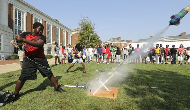 Dontavious Maxwell and Janaryah Williams, students from University Place Elementary School, fire water bottle rockets as they participate in the University of Alabama School of Engineering's E Day on the Shelby Quad Thursday, Oct. 3, 2019. E Day is used to promote the school of engineering to students in the primary and secondary school systems to show them the possibilities that exist in an engineering education and career. [Staff Photo/Gary Cosby Jr.]