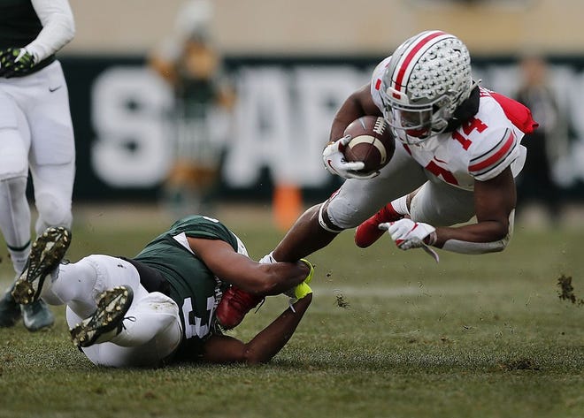 Michigan State defensive back Xavier Henderson trips Ohio State receiver K.J. Hill during a game in East Lansing, Mich., on Nov. 10, 2018. Henderson, a Pickerington Central graduate, will play at Ohio Stadium for the first time when the Spartans face the Buckeyes this week. [Samantha Madar/Dispatch]