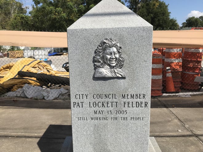 This monument to Pat Lockett-Felder, with names of Eastside notables in small print on the sides, is the ultimate bad example of City Council's "lollipop" funds. Irony of ironies, in the background is equipment for an Eastside drainage project, a much better use of taxpayer funds. (Mike Clark/Florida Times-Union)